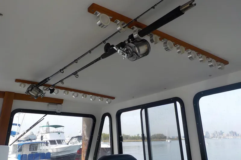 Slide: The Image of Interior of 2008 Calvin Beal Downeast boat with fishing rod holder on ceiling. - 30