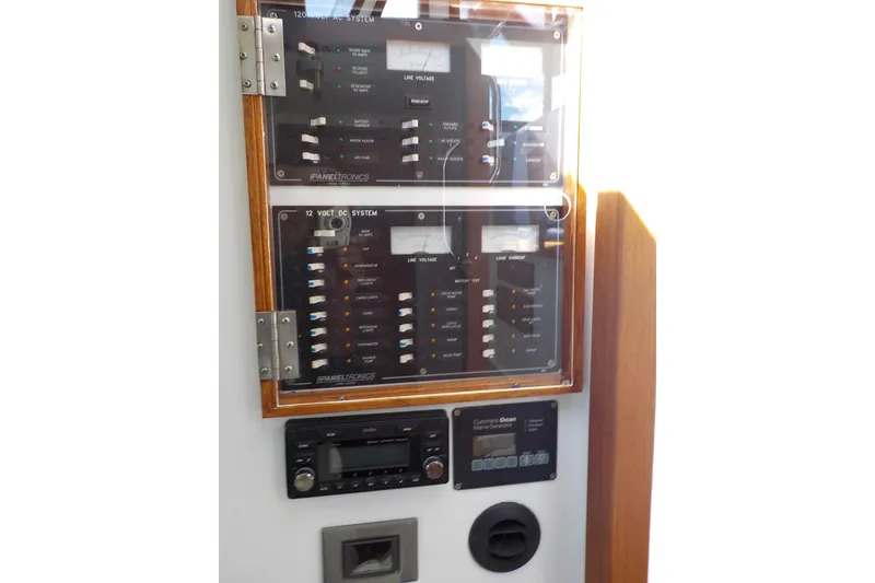Slide: The Image of Electrical panel of a 2008 Calvin Beal Downeast boat, featuring control switches and gauges. - 42