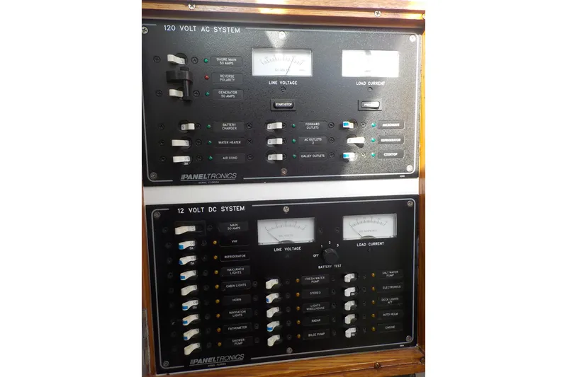 Slide: The Image of Electrical control panels on a 2008 Calvin Beal Downeast boat, featuring AC and DC systems. - 43
