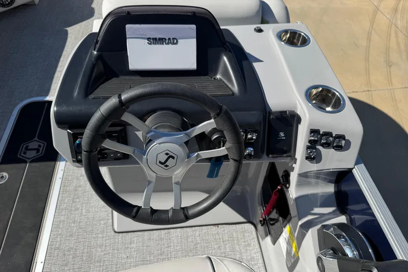 Slide: The Image of Steering console of 2025 Harris Sunliner 230 boat with Simrad display and controls. - 4