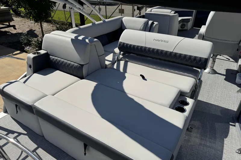 Slide: The Image of 2025 Harris Sunliner 230 pontoon boat with luxurious seating and cup holders. - 6