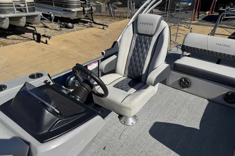 Slide: The Image of 2025 Harris Sunliner 230 boat interior with steering wheel and luxurious seating. - 7