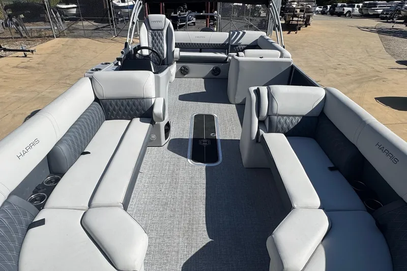 Slide: The Image of 2025 Harris Sunliner 230 pontoon boat with spacious seating and modern design. - 9