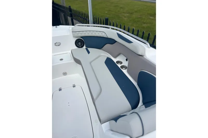 Slide: The Image of 2026 Hurricane SunDeck 2400 OB boat interior with cushioned seating and cup holders. - 10