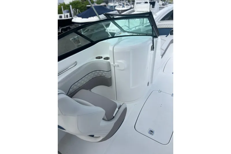 Slide: The Image of 2026 Hurricane SunDeck 2400 OB boat interior with seating and windshield. - 11