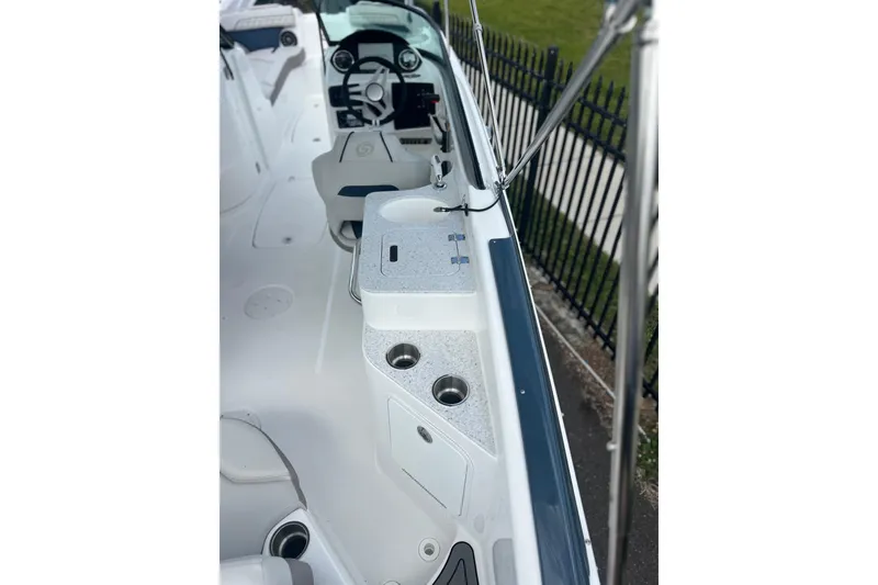 Slide: The Image of 2026 Hurricane SunDeck 2400 OB boat interior with seating and control panel. - 13