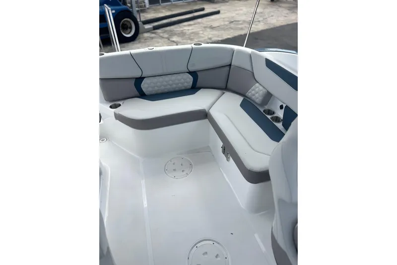 Slide: The Image of 2026 Hurricane SunDeck 2400 OB boat interior with cushioned seating and cup holders. - 16