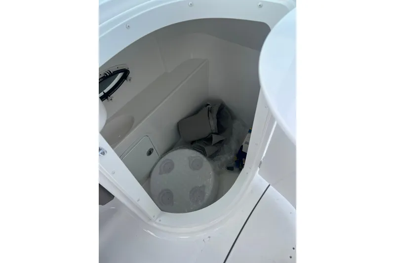 Slide: The Image of Interior storage compartment of 2026 Hurricane SunDeck 2400 OB boat, featuring organized space. - 17