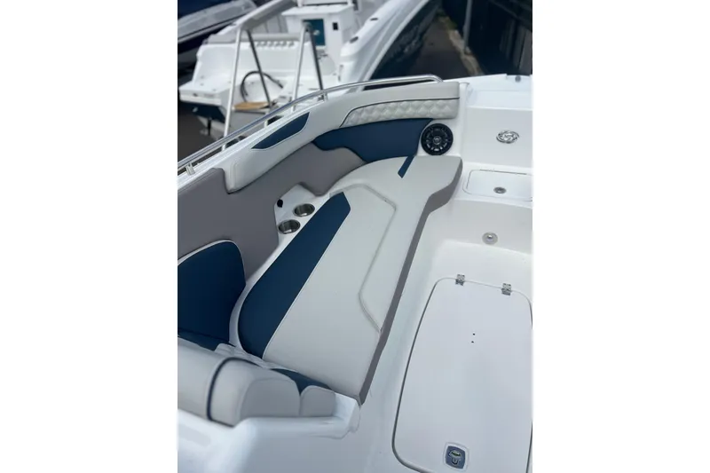 Slide: The Image of 2026 Hurricane SunDeck 2400 OB boat interior with blue and white seating. - 9