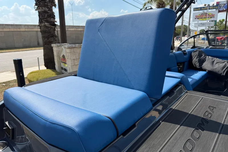 Slide: The Image of 2026 Moomba Tykon boat with blue seating, showcased at South Austin Marine. - 15
