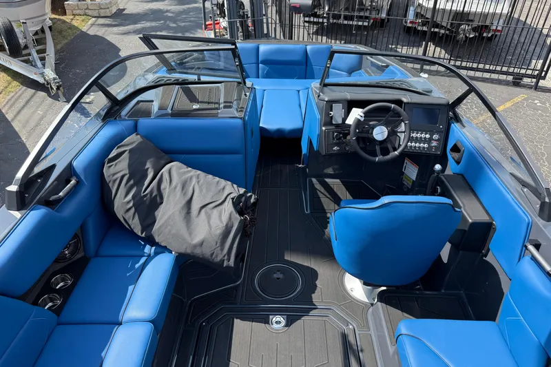 Slide: The Image of 2026 Moomba Tykon boat interior with blue seating and modern dashboard design. - 18