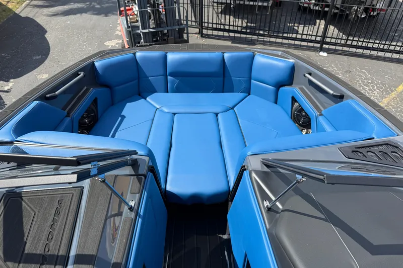 Slide: The Image of 2026 Moomba Tykon boat with luxurious blue seating in the bow area. - 19