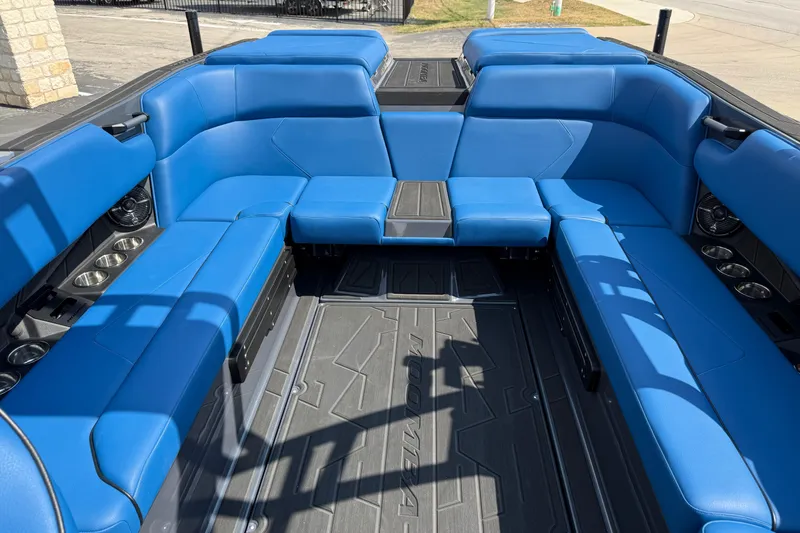 Slide: The Image of 2026 Moomba Tykon boat interior with blue seating and cup holders. - 20