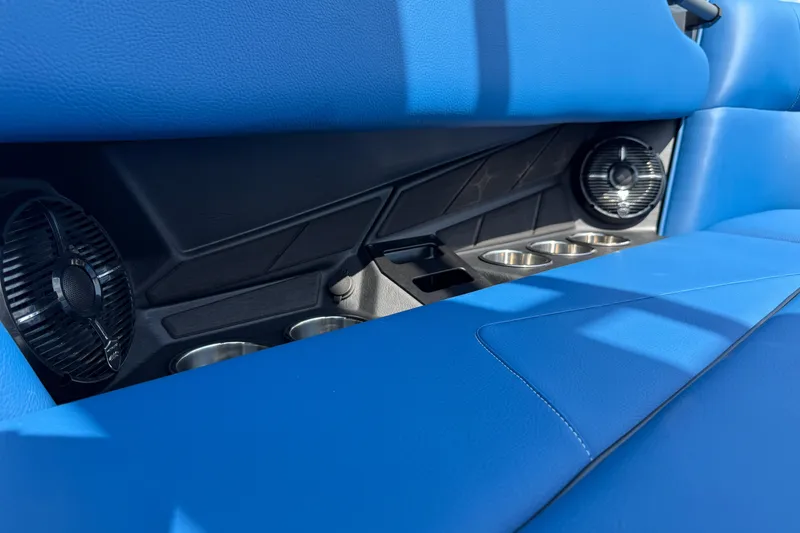 Slide: The Image of 2026 Moomba Tykon interior with blue seating, cup holders, and speakers. - 21