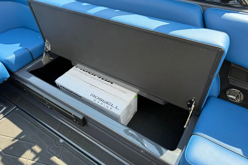 Slide: The Image of 2026 Moomba Tykon boat storage compartment with blue seating and Roswell Marine box. - 24