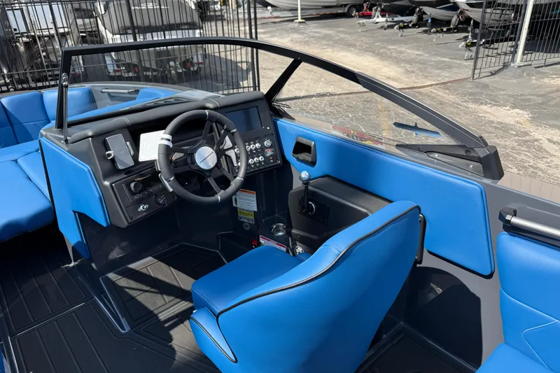 Slide: The Image of 2026 Moomba Tykon boat interior with blue seating and modern dashboard controls. - 28