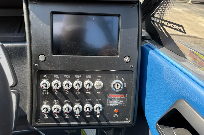 Slide: The Image of Control panel of 2026 Moomba Tykon boat with switches and display screen. - 30