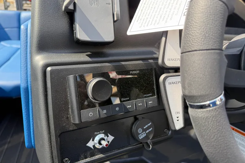 Slide: The Image of Control panel of 2026 Moomba Tykon boat with audio system and steering wheel. - 31