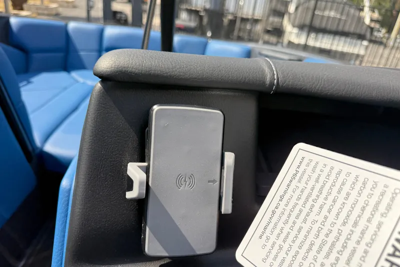 Slide: The Image of 2026 Moomba Tykon interior with wireless charging dock and blue seating. - 32