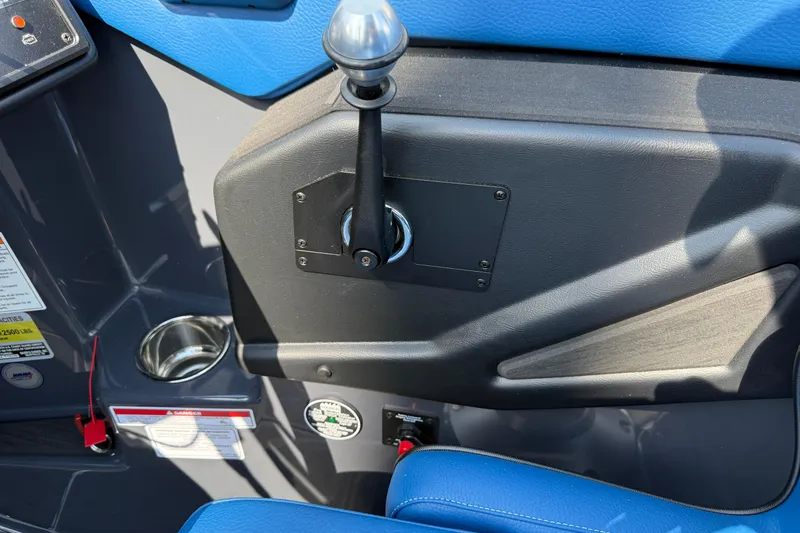 Slide: The Image of Control panel of 2026 Moomba Tykon boat with blue seating and cup holder. - 35