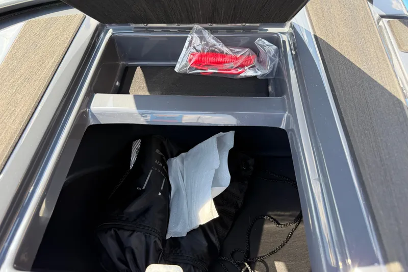 Slide: The Image of Open storage compartment in 2026 Moomba Tykon boat with accessories inside. - 37