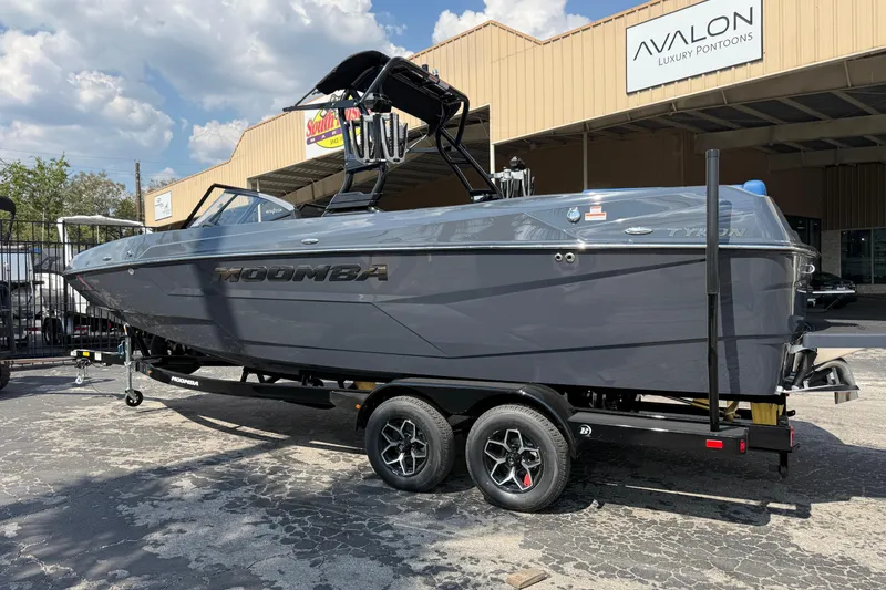 Slide: The Image of 2026 Moomba Tykon boat on trailer outside Avalon Luxury Pontoons dealership. - 42
