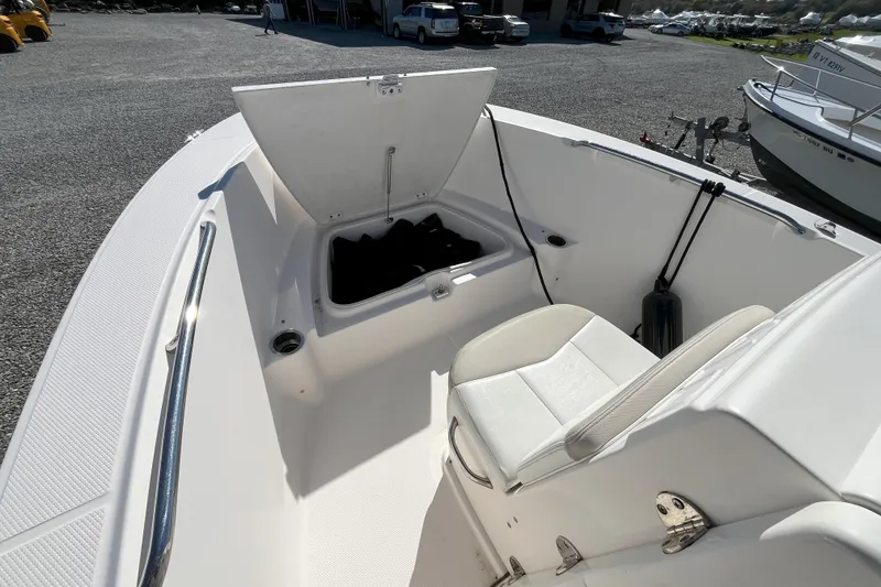 Slide: The Image of 2014 Robalo R180 Center Console boat with open storage compartment and seating. - 4