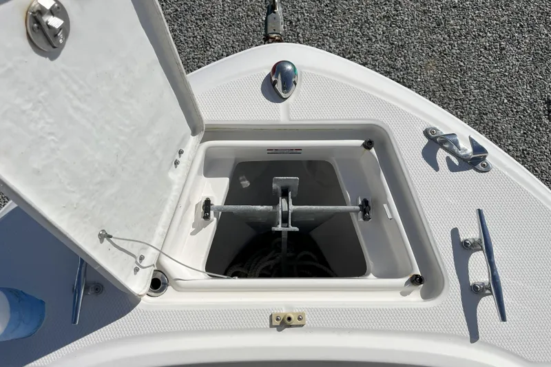 Slide: The Image of Open anchor compartment on 2014 Robalo R180 Center Console boat, showing anchor and rope. - 5