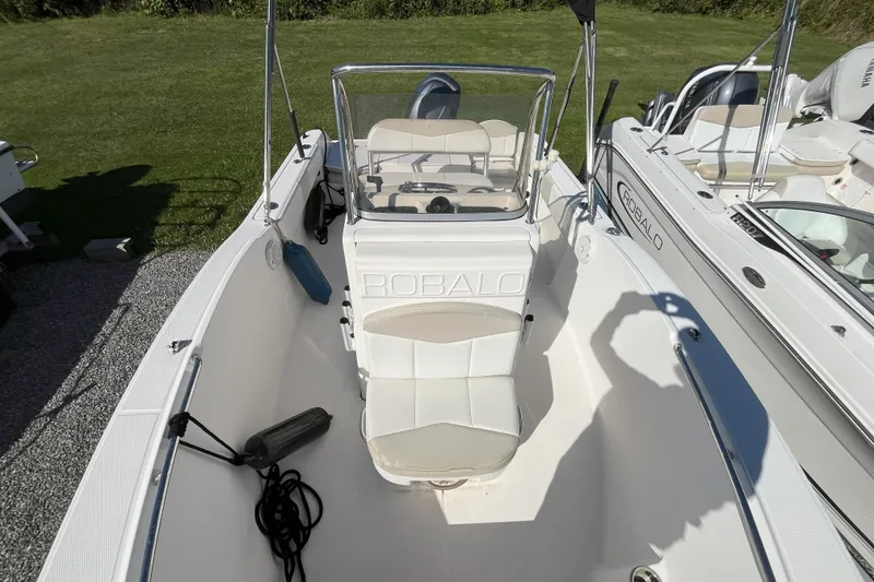Slide: The Image of 2014 Robalo R180 Center Console boat interior with seating and steering console. - 6