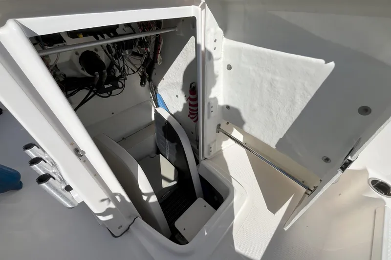 Slide: The Image of 2014 Robalo R180 Center Console storage compartment with wiring and equipment. - 7