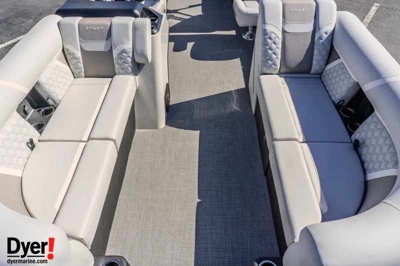 Slide: The Image of 2026 Crest Conquest 230 SLC pontoon boat interior with luxurious seating and cup holders. - 10