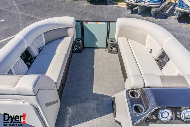 Slide: The Image of 2026 Crest Conquest 230 SLC pontoon boat interior with plush seating and modern dashboard. - 14