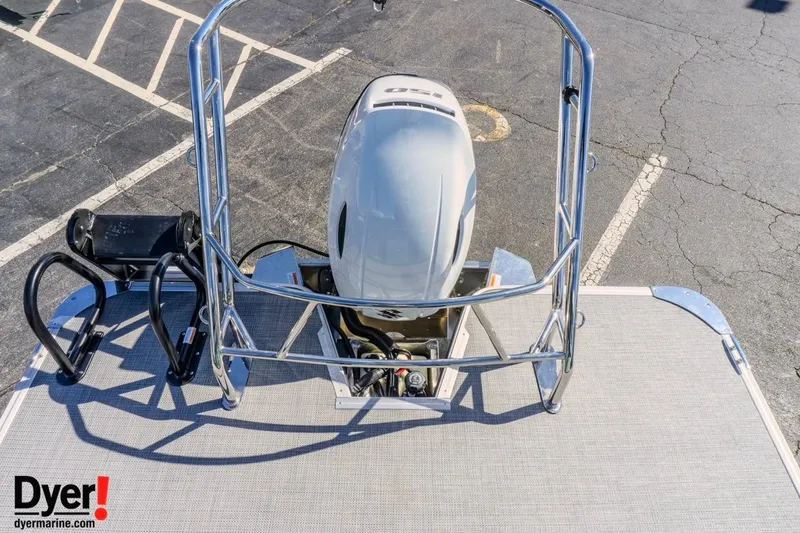 Slide: The Image of 2026 Crest Conquest 230 SLC boat with outboard motor and safety railing, parked on asphalt. - 15