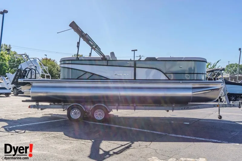 Slide: The Image of 2026 Crest Conquest 230 SLC pontoon boat on trailer in parking lot. - 6