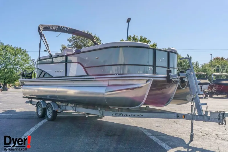 Slide: The Image of 2026 Crest Conquest 230 SLC pontoon boat on trailer in parking lot. - 8