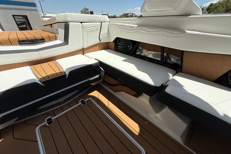 Slide: The Image of 2025 Nautique Super Air Nautique G23 interior with luxurious seating and teak flooring. - 12