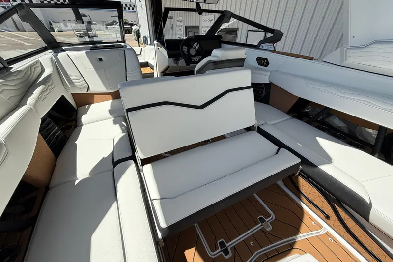 Slide: The Image of 2025 Nautique Super Air Nautique G23 interior with white seating and modern design. - 15