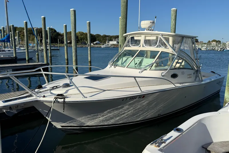 Slide: The Image of 2005 Albemarle 280 Express Fisherman boat docked in a marina under clear blue skies. - 0