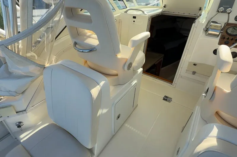 Slide: The Image of 2005 Albemarle 280 Express Fisherman boat interior with white seating and helm area. - 10