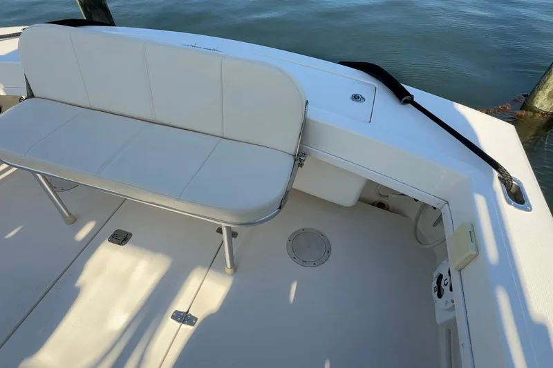 Slide: The Image of 2005 Albemarle 280 Express Fisherman boat interior with white seating and deck. - 13