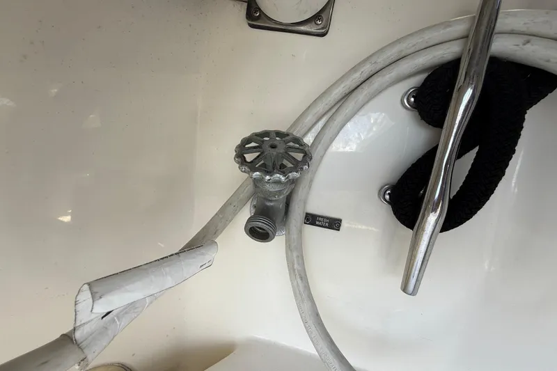 Slide: The Image of 2005 Albemarle 280 Express Fisherman boat deck with hose and faucet. - 18