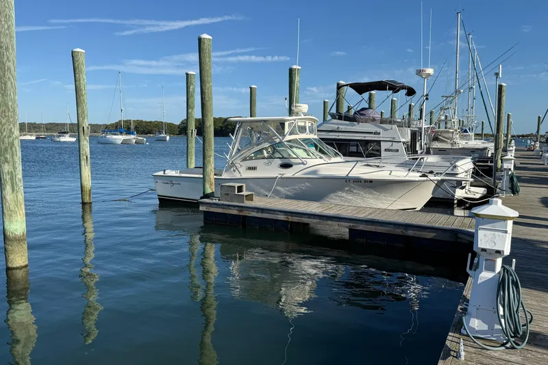 Slide: The Image of 2005 Albemarle 280 Express Fisherman docked at a marina on a sunny day. - 2