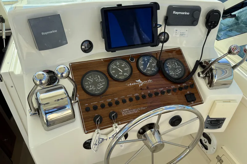 Slide: The Image of Control panel of 2005 Albemarle 280 Express Fisherman with gauges and Raymarine electronics. - 25