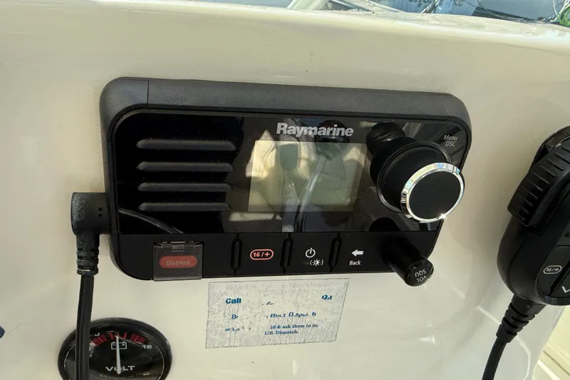 Slide: The Image of Raymarine marine radio on 2005 Albemarle 280 Express Fisherman boat dashboard. - 29