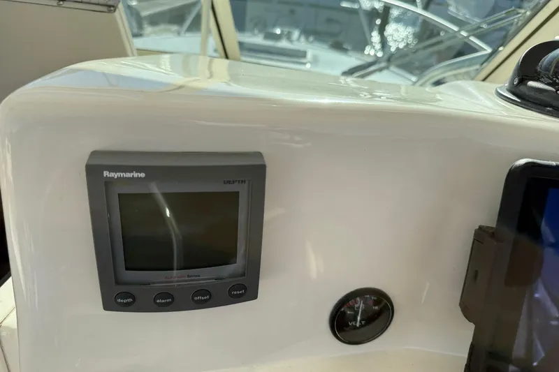 Slide: The Image of 2005 Albemarle 280 Express Fisherman dashboard with Raymarine depth display and voltmeter. - 30