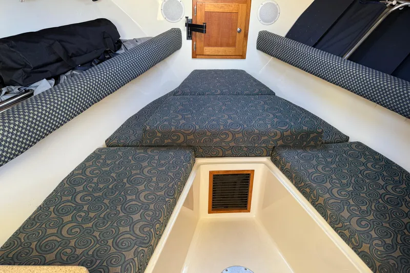 Slide: The Image of 2005 Albemarle 280 Express Fisherman cabin interior with patterned cushions and wooden door. - 35
