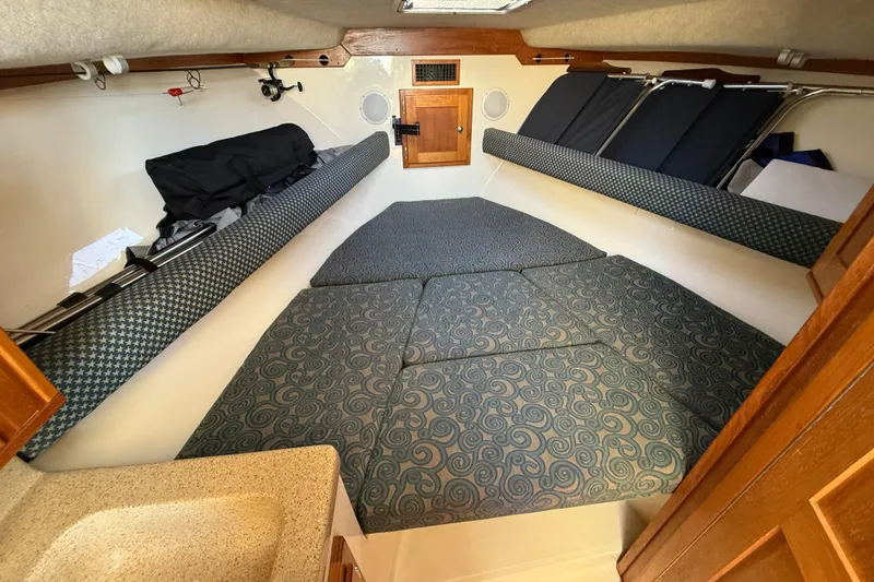 Slide: The Image of 2005 Albemarle 280 Express Fisherman cabin interior with cushioned seating and compact sink. - 36