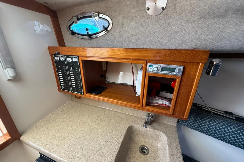 Slide: The Image of 2005 Albemarle 280 Express Fisherman cabin interior with control panel and sink. - 38