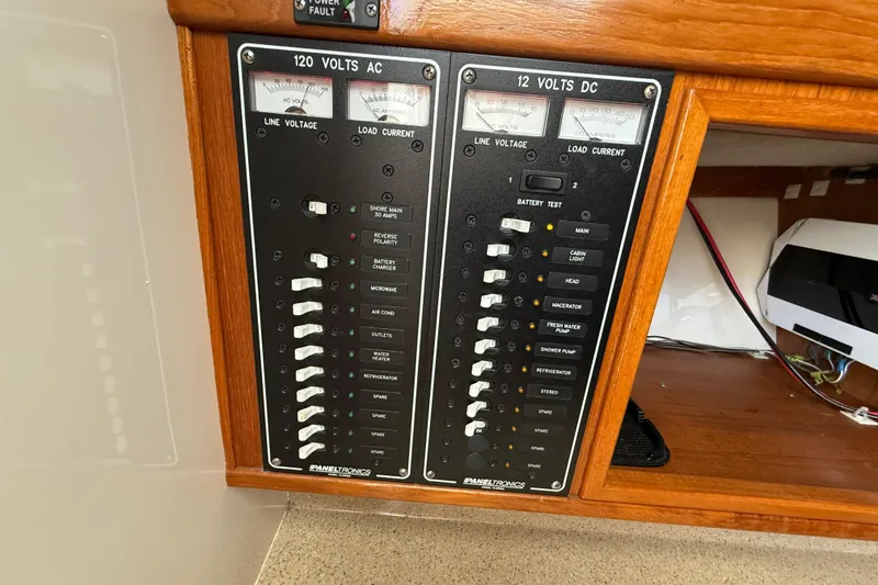 Slide: The Image of Electrical panel of a 2005 Albemarle 280 Express Fisherman boat, featuring AC and DC controls. - 42