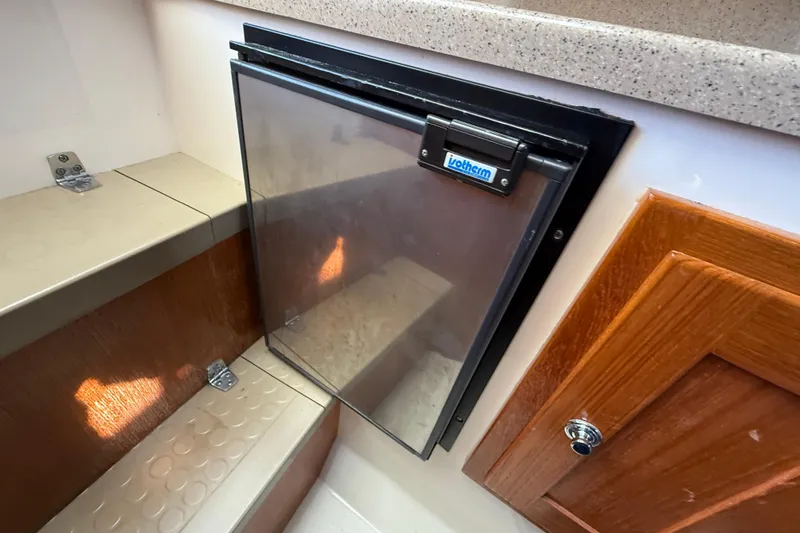 Slide: The Image of 2005 Albemarle 280 Express Fisherman interior with Isotherm fridge and wooden cabinetry. - 44